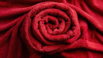 A close up of a red towel with the shape of a rose, AI photo