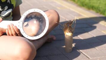 close-up sun rays make bunch of grass. sunlight through magnifying glass video
