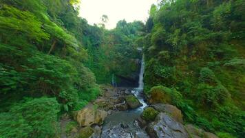 Smooth FPV flight of stunning tropical waterfall in the jungle in Indonesia. video
