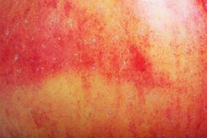 The texture of a red and yellow apple as a macro photo background.