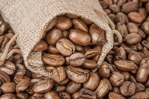 Natural roasted coffee beans in a bag as a background. photo