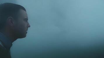 Despite the fog obscuring their vision the persons senses seem more heightened as they constantly scan their surroundings for any signs of danger.. video