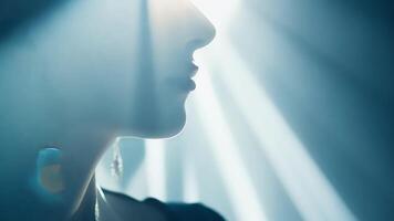 A closeup of a models face with intricate patterns created by shadows and light adding depth and interest to the image.. video