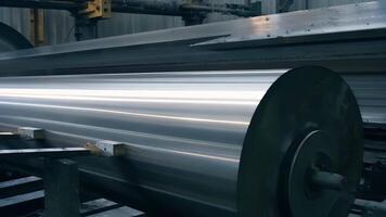 Closeup of heavy steel beams being pressed and shaped into various forms by massive mechanical rollers.. video