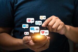 Young Man Using Smartphone with Multiple Social Media Notifications Displayed on Screen, Engaging in Digital Communication and Social Networking, Busy Lifestyle with Technology Interaction photo