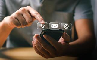 Man Using Smartphone to Access Communication Icons for Call, Email, and Internet, Representing Modern Digital Connectivity and Technology in Everyday Life photo