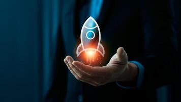 Businessman Holding Holographic Rocket Symbolizing Startup Launch and Innovation, Emphasizing Technological Advancement and Entrepreneurial Success, Global tech startup innovates to connect photo