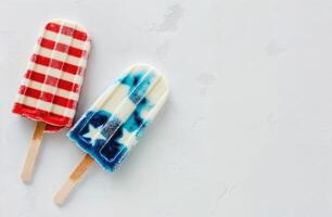 Popsicles in American flag colors on a white textured background, top view, patriotic concept, space for text. photo