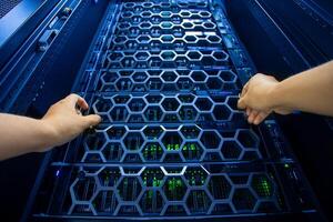 IT engineer repairing a server in a datacenter photo
