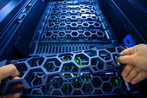 IT engineer repairing a server in a datacenter photo