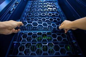 IT engineer repairing a server in a datacenter photo