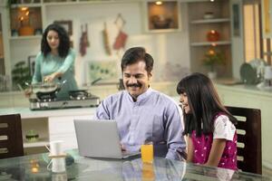 Father And Daughter Surfing On Internet On Laptop photo