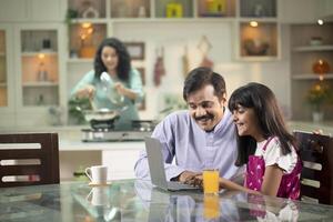 Excited Dad And Daughter Using Laptop Together photo