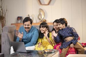 Father Mother And Son, Daughter Having Call With Relatives photo
