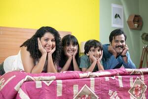 Modern Family Keeping Hand On Cheek While Looking At Camera photo