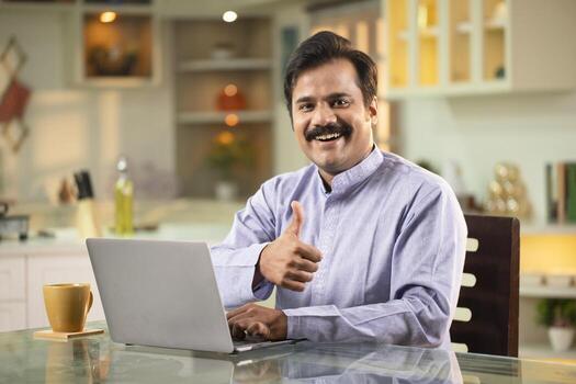 Man Showing Thumbs Up While Looking At Camera photo