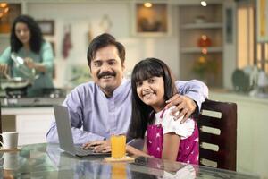 Handsome Dad And Daughter Smiling While Looking At Camera photo