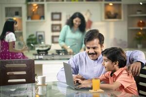 Dad Teaching Son To Use Laptop photo