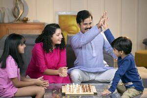 Adorable Family Playing Chess Game photo