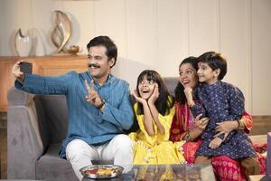 Father Mother Taking Selfie Or Self Photograph At Home With Kids photo