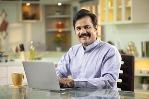 Smiling Man Posing In Front Of Camera photo