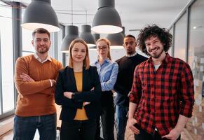Diverse Business Team Standing United in Modern Office Ready for New Challenges. photo