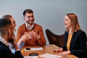 In the vibrant ambiance of a modern startup office, a diverse team of business professionals engage in discussions on various projects and develop new business strategies, epitomizing creativity and photo