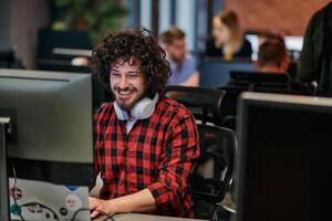 Focused Programmer With Afro Hairstyle in Plaid Shirt Working on Computer in Office Environment photo
