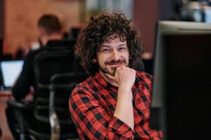 Focused Programmer With Afro Hairstyle in Plaid Shirt Working on Computer in Office Environment photo
