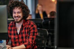 Focused Programmer With Afro Hairstyle in Plaid Shirt Working on Computer in Office Environment photo