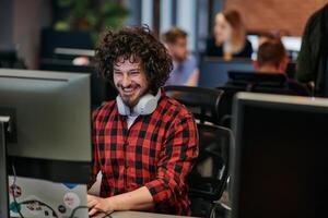 Focused Programmer With Afro Hairstyle in Plaid Shirt Working on Computer in Office Environment photo