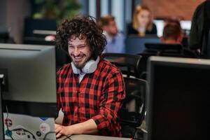 Focused Programmer With Afro Hairstyle in Plaid Shirt Working on Computer in Office Environment photo