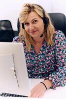 Friendly Call Center Agent Answering Incoming Calls with Headset Providing Remote Customer Service. photo