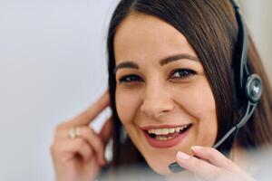 Friendly Call Center Agent Answering Incoming Calls with Headset Providing Remote Customer Service. photo