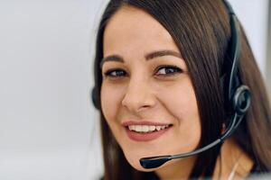 Friendly Call Center Agent Answering Incoming Calls with Headset Providing Remote Customer Service. photo