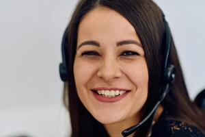 Friendly Call Center Agent Answering Incoming Calls with Headset Providing Remote Customer Service. photo