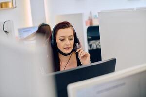 Friendly Call Center Agent Answering Incoming Calls with Headset Providing Remote Customer Service. photo