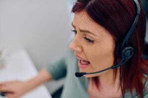 Friendly Call Center Agent Answering Incoming Calls with Headset Providing Remote Customer Service. photo