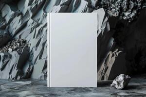 Blank white book for mockup placed on rocks, photo