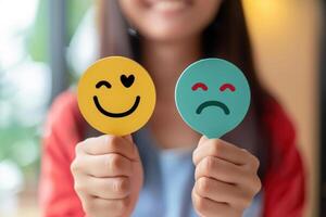 Contrasting Emotions on Hands Holding Red and Green Sad Face Icons for Feedback and Customer Satisfaction. photo