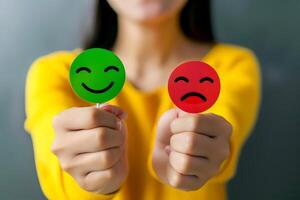 Contrasting Emotions Hands Holding Red and Green Sad Face Icons for Feedback and Customer Satisfaction. photo