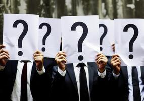 business man holding up an empty sheet of paper . photo
