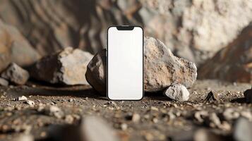 Abstract empty smartphone with mock up screen leaning on rock background photo
