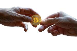 A male hand passes a shiny golden Bitcoin to another person against a white background .symbolizing cryptocurrency transactions. photo