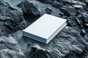 Blank white book for mockup placed on rocks, photo