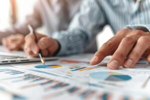 Business professionals analyzing financial data charts and graphs, discussing performance, and planning strategy at the office. photo