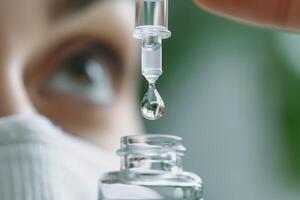 Close-up of a scientist in a mask using a dropper to transfer liquid into a small bottle in a laboratory setting. photo