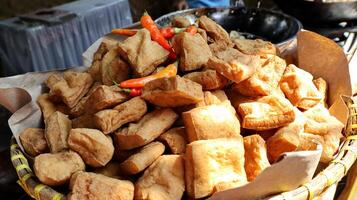 Fried tofu and chili in a bamboo basket photo