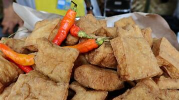 Fried tofu and chili in a bamboo basket photo