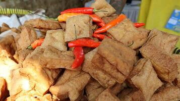 Fried tofu and chili in a bamboo basket photo